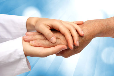 This is a picture of a doctor holding the hands of a elderly person